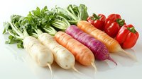 Fresh colorful root vegetables and red bell peppers arranged in row on white surface, including daikon radish, carrots, purple radish, and bok choy greens.