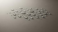 Water droplets scattered on a smooth gray surface, forming an elegant cluster pattern with realistic shadows and reflections.