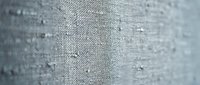 Close-up of gray woven fabric texture with fine weave pattern, suitable for textile design, fashion backgrounds, and material mockups.