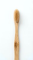 Natural bamboo toothbrush with soft bristles isolated on white background for eco-friendly dental care and sustainable oral hygiene products.