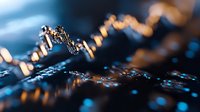 Macro shot of water droplets on metallic surface with blue and golden light reflections, creating abstract bokeh effect for design and background use.