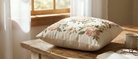 Floral embroidered cushion on wooden bench by sunny window. Cozy home decor with botanical needlework pillow in warm natural light for interior design projects.