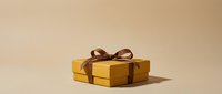 Wrapped golden gift box with brown ribbon bow on neutral beige background, isolated for holiday, celebration, and promotional design projects.