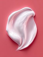 White creamy cosmetic texture smear on pink background, smooth glossy moisturizer or skincare product sample showing rich luxurious consistency.