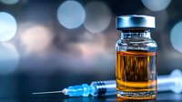 Medical vial with amber liquid and syringe on blurred bokeh background, dramatic lighting creates modern pharmaceutical atmosphere for healthcare concepts.