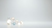 Transparent glass and crystal spheres with light blue gemstone clustered on white background, isolated for design projects.