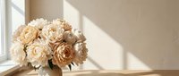 Elegant neutral beige and cream artificial peony bouquet in soft natural sunlight on windowsill for home decor and interior design projects.