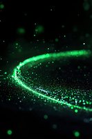 Glowing green particles forming curved trail against dark background with floating bokeh lights and sparkles, creating magical atmospheric effect.