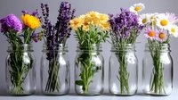 Fresh wildflowers and garden blooms arranged in glass mason jars against gray background, featuring lavender, chrysanthemums, daisies and pink flowers in rustic display.