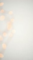 Soft blurred bokeh lights on neutral beige background creating dreamy atmosphere for holiday celebrations, wedding invitations and festive designs.