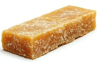 Block of aged parmesan cheese with crystalline texture and golden color on white background, isolated macro shot showing detailed grainy structure.