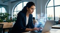 Professional businesswoman using laptop with digital interface icons in modern office workspace with arched windows and natural lighting for technology concepts.