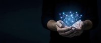 Businessman hands holding glowing digital network connections with blue light effects on dark background for technology and innovation concepts.