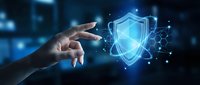 Hand reaching toward glowing digital security shield with network connections representing cybersecurity protection and data safety technology.