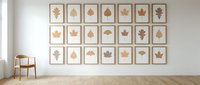 Modern minimalist living room with botanical leaf art gallery wall featuring framed autumn foliage prints in natural wood frames on white wall.