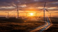 Wind turbines on rolling hills at golden sunset with light trails from passing vehicles creating sustainable energy landscape for environmental concepts.