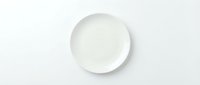 Empty white ceramic plate on clean white background isolated for kitchen and dining design projects.