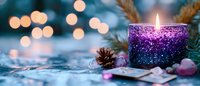 Glowing purple candle with sparkly holder creates cozy atmosphere among pine branches and decorations against blurred bokeh lights background for winter holiday season.