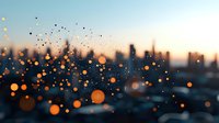 Blurred urban cityscape at dusk with floating golden bokeh lights creating magical atmosphere. Defocused city skyline silhouette against warm sunset sky.