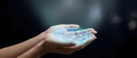 Young woman's hands holding glowing digital hologram with blue light, representing technology, innovation, and future digital solutions for business and communication.