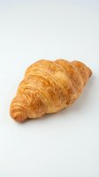 Fresh golden croissant with flaky layers isolated on white background for bakery menu design and culinary projects.