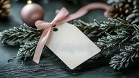 Blank gift tag with pink ribbon on evergreen branches and ornaments for holiday present wrapping and festive decoration projects.