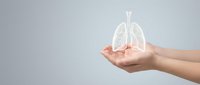 Human hands holding glowing lungs hologram representing respiratory health, medical care, and pulmonary wellness concepts for healthcare design.