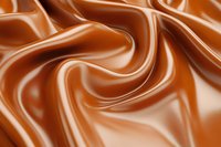 Smooth flowing caramel waves create abstract swirls and curves in rich brown tones, highlighting silky texture and glossy surface for food and confectionery designs.
