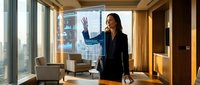 Professional Asian businesswoman presenting data analytics on interactive display in modern corporate boardroom with city skyline view during daytime meeting.