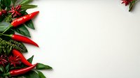 Fresh red chili peppers and star anise arranged with green leaves creating decorative border on white background, copy space for food or recipe design.