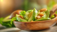 Fresh snow peas and roasted peanuts served in wooden bowl on rustic table with natural lighting, macro food photography for healthy eating concept.