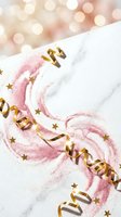 Pink glitter swirls with golden ribbons and stars on white marble surface with warm bokeh lights creating festive celebration atmosphere.