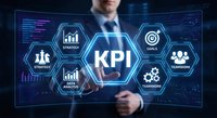 Professional businessman analyzing KPI dashboard with hexagonal interface displaying strategy metrics, goals and teamwork icons on digital screen.