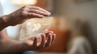 Hands holding glowing digital brain hologram representing artificial intelligence, machine learning, and neural network technology for innovation and digital transformation concepts.