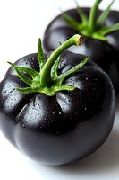 Fresh black tomatoes with water drops and green stems on white background, macro photography showing texture and natural moisture for food design.