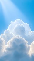 Majestic white cumulus clouds against bright blue sky background with sunlight streaming through, creating ethereal atmospheric scene for spiritual concepts.