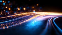Glowing curved light trails with sparkling particles against dark background create dynamic motion effect in blue and golden colors. Abstract technology concept.