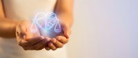 Hands holding glowing scales and brain icon symbolizing balance between logic and emotion, ethics and decision making in business and law.