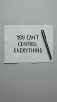 Motivational quote on paper with pen about letting go of control and accepting life circumstances for mental health and personal growth.