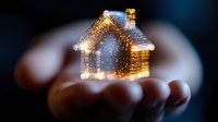 Glowing miniature house floating above open palms against dark background, magical holiday atmosphere with sparkles and bokeh lights for real estate concepts.