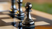 Black chess pawn on wooden chessboard with shallow depth of field, dramatic lighting highlights strategy and competition in business and gaming.