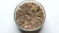 Healthy chia seed pudding topped with pumpkin seeds in white bowl, nutritious breakfast dessert for wellness and clean eating lifestyle.
