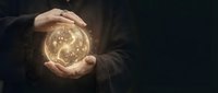 Businessman hands protecting glowing Earth globe with network connections on dark background for environmental protection and global business concepts.