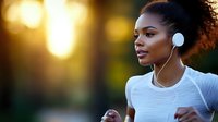 Young African American woman jogging outdoors with headphones during golden hour sunset, healthy lifestyle and fitness motivation concept.