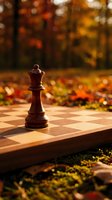 Wooden chess king piece standing on chessboard outdoors with warm autumn foliage background creating strategic game concept for business planning.