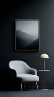Minimalist interior with gray armchair, modern floor lamp and framed mountain landscape artwork against dark wall. Contemporary home decor setting.