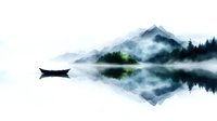 Tranquil mountain lake with floating boat silhouette against misty peaks and evergreen forest, reflected in mirror-like water surface creating symmetrical landscape.