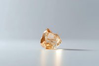 Raw uncut champagne diamond crystal on minimalist white background with soft shadow, showcasing natural gemstone formation.