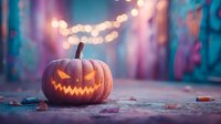 Glowing carved pumpkin jack-o-lantern with zigzag smile on rustic surface with colorful bokeh lights and autumn leaves creating festive Halloween atmosphere.