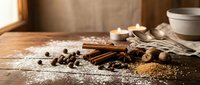 Baking ingredients arranged on wooden surface with cinnamon sticks, coffee beans, nutmeg, and flour for culinary and recipe content.
